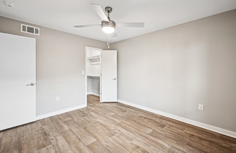 Serene bedroom area in the D5 floor plan at Windridge On The Parkway Apartments in Dallas, TX